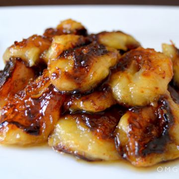 Closeup of caramelized bananas on a plate.