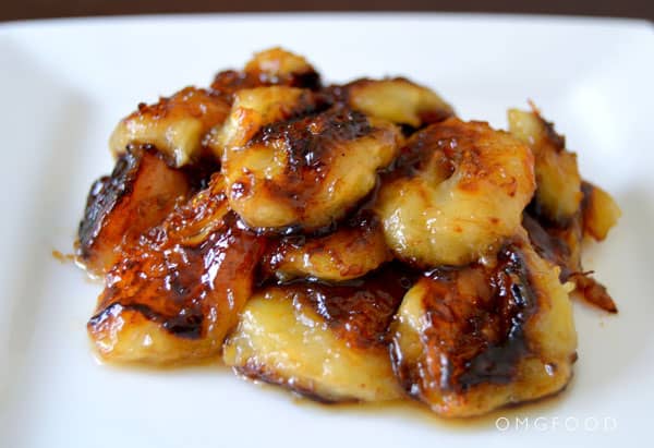 Closeup of caramelized bananas on a plate.