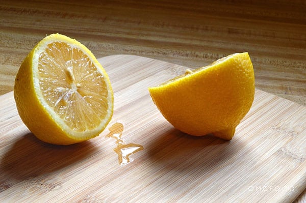 Cut lemon on a cutting board.