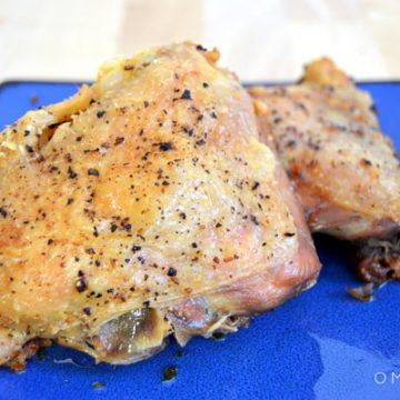 Closeup of roasted chicken on a plate.