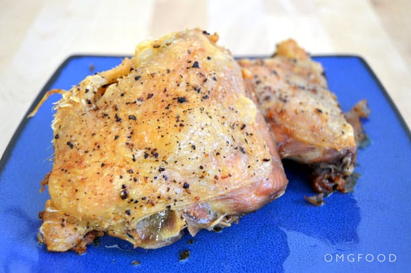 Closeup of roasted chicken on a plate.