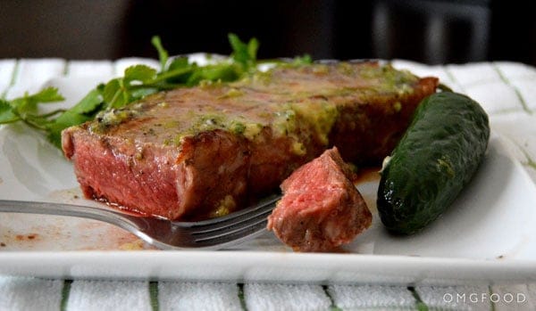 A closeup of steak on a plate.