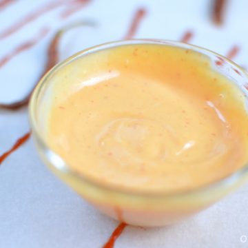 A closeup of sriracha aoili in a small bowl.