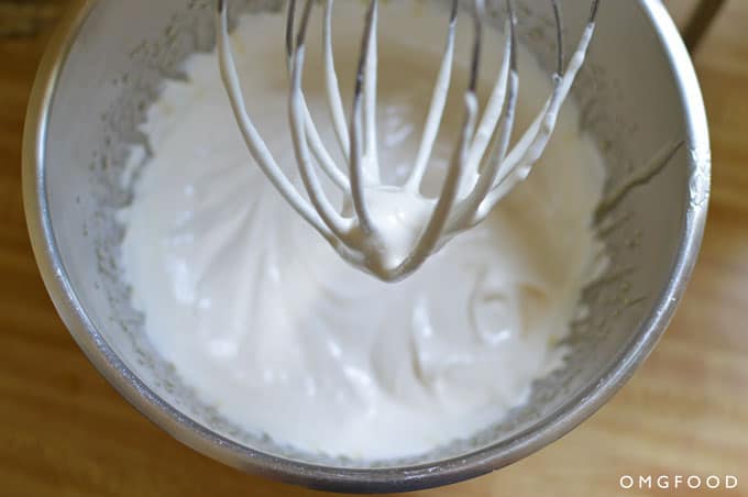 Closeup of marshmallow sauce in a stand mixer bowl.
