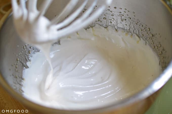 Closeup of marshmallow sauce in a stand mixer bowl.