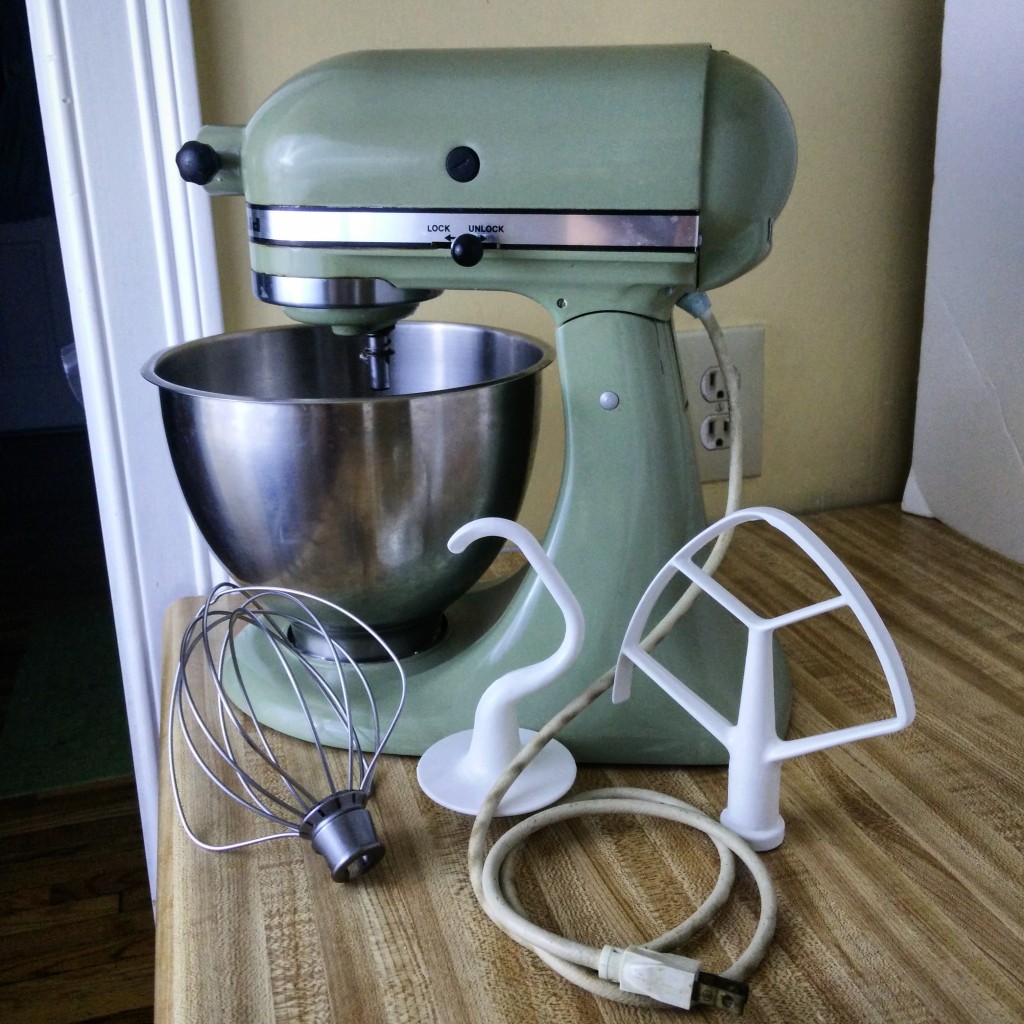 A stand mixer and accessories on a countertop.