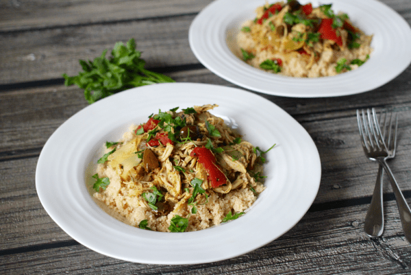 Two plates of shredded chicken and rice.