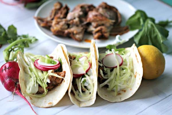 Closeup of tacos on a tabletop.