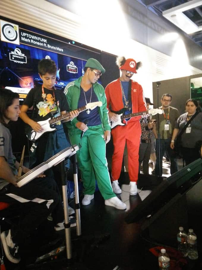 A group of people standing on a stage playing a game.