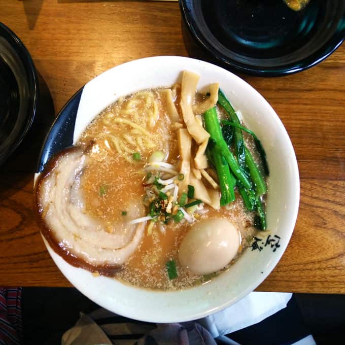 A closeup of a bowl of ramen on a table.