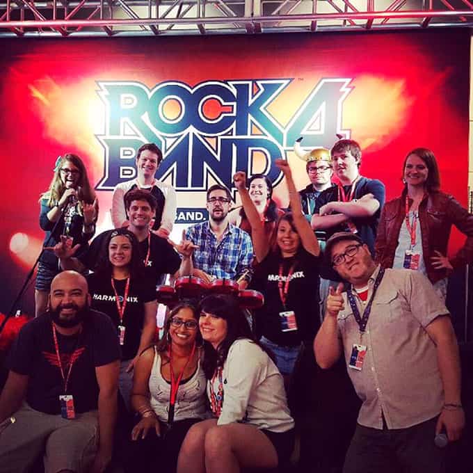 A group of people posing for a photo in front of a stage.