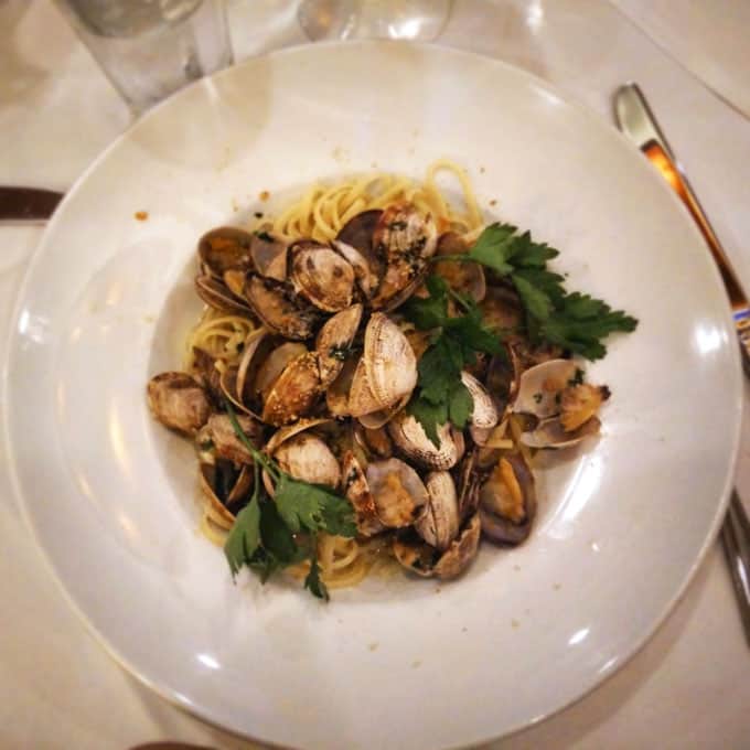 A plate of clams and pasta on a table.