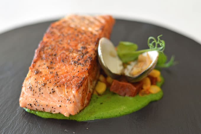 A closeup of salmon on a plate.