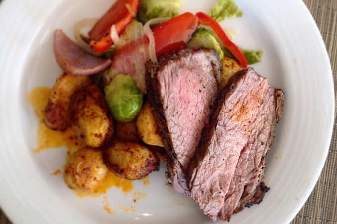 A plate of steak, potatoes, and mixed vegetables.