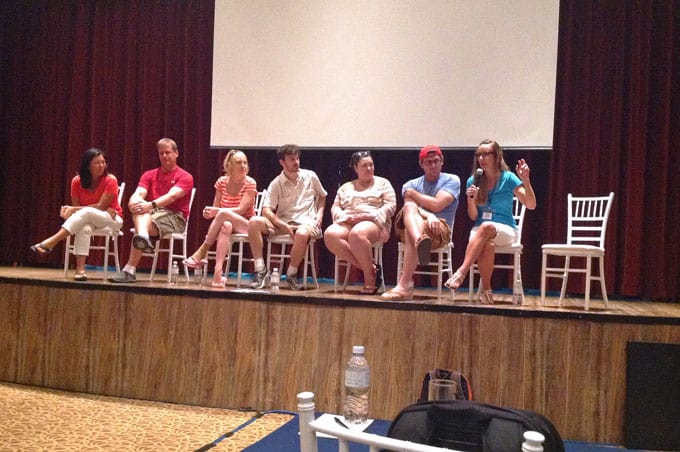 A group of people sitting on a stage.