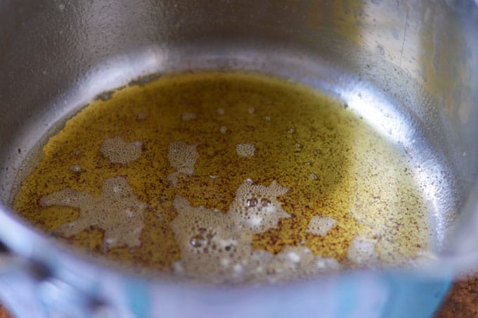 A close up of browned butter in a saucepan.