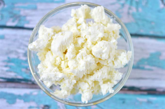 Closeup of crumbled feta in a small bowl.