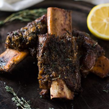 Roasted beef ribs on a platter.