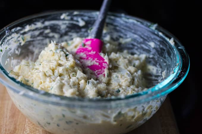 A bowl of cauliflower fritter mixture.