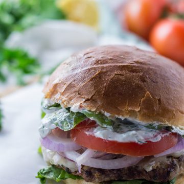 A close up of a burger on a plate.