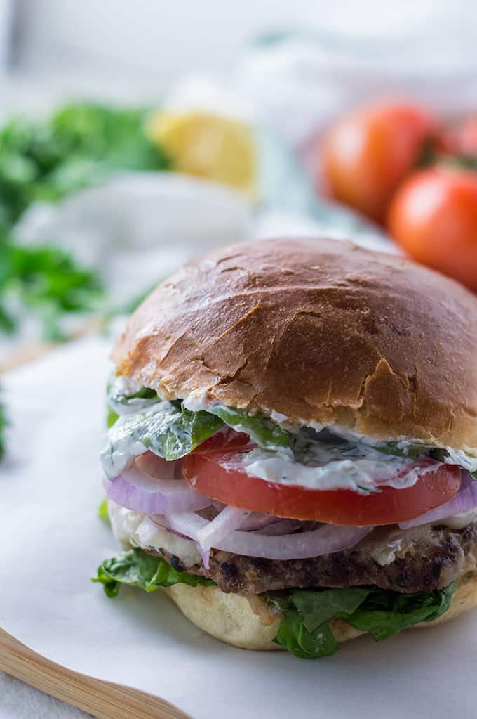 A close up of a burger on a plate.