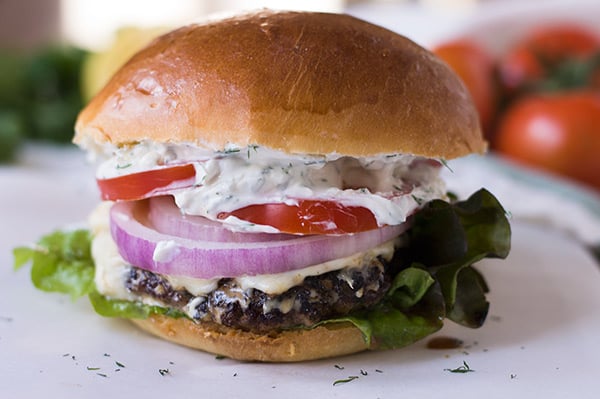 A close up of a burger on a plate.