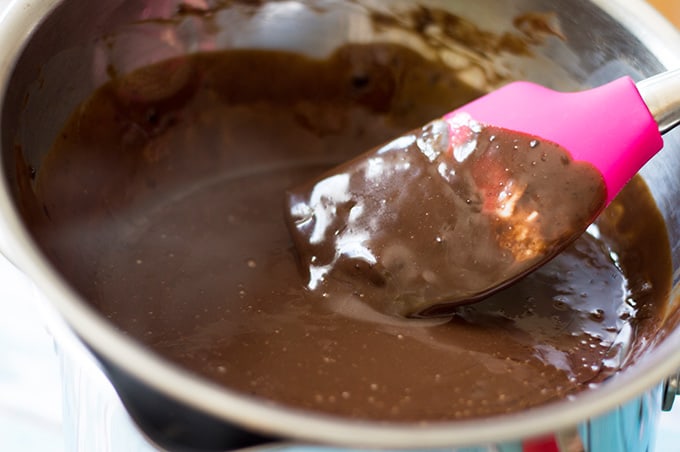 Closeup of a silicone spatula in a bowl of chocolate ganache.