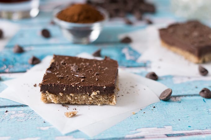 A slice of chocolate pie bar on a parchment squre.