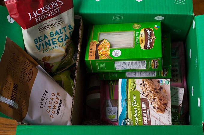 Assorted packaged food items in an open box.