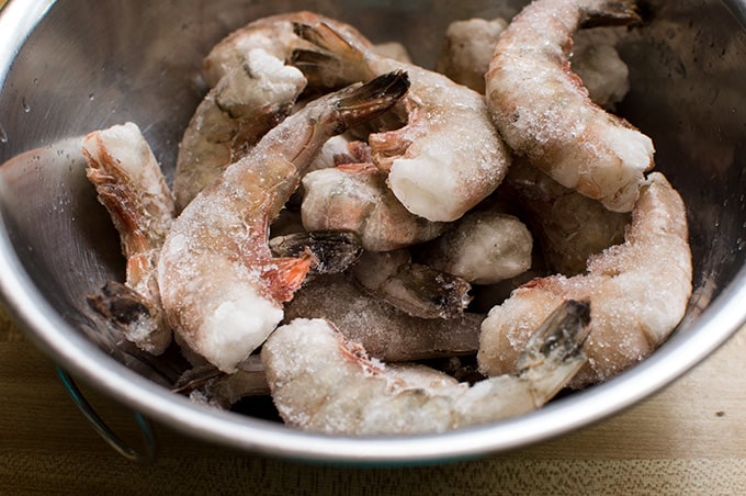 Closeup of frozen shrimp in a bowl.