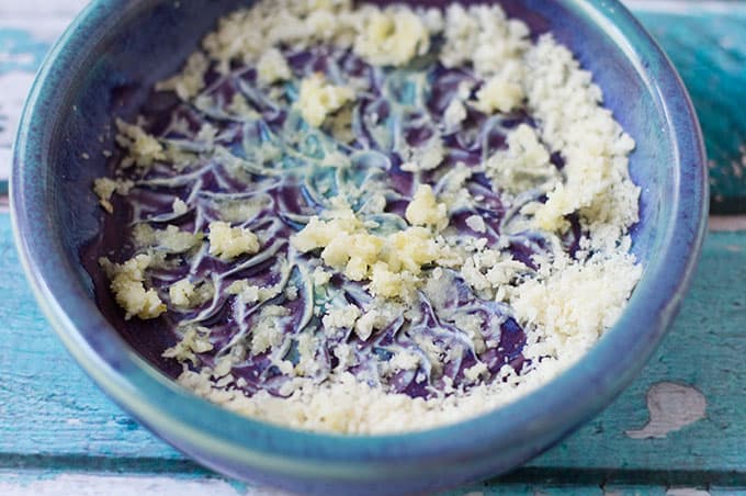 Grated garlic and cheese in a small dish.