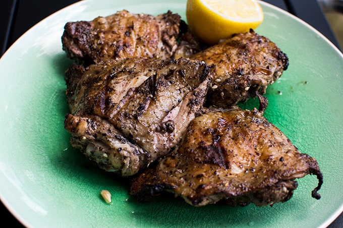 A close up of grilled chicken on a plate.