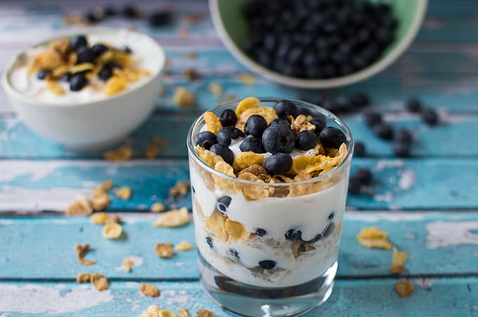 Blueberry yogurt parfait in a glass bow.