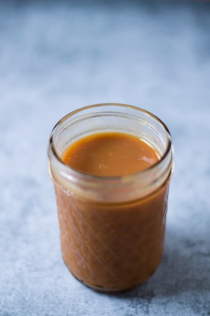 Closeup of a jar of dulce de leche.
