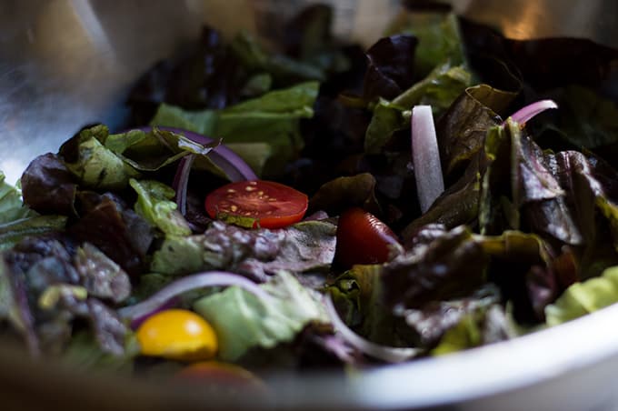 Close up of salad in a mixing bowl.