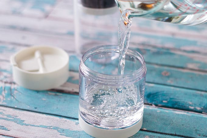 Water being poured into a cold brew coffee maker.