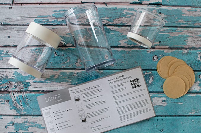 Cold brew maker pieces and instructions on a table.