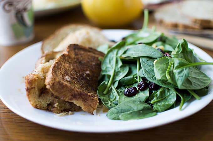 Closeup of toast and spinach salad on a plate.