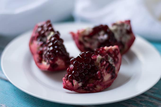 Close up of cut pomegranate on a plate.