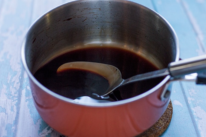 Pomegranate molasses in a saucepan.