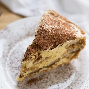 Close up of a slice of tiramisu pie.