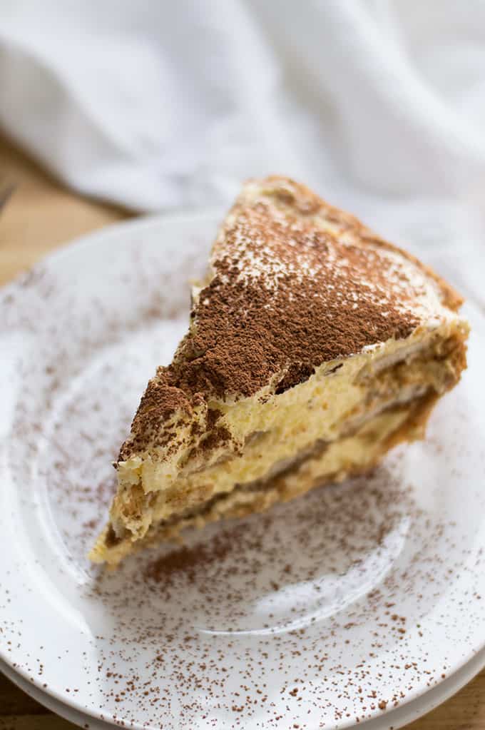 Close up of a slice of tiramisu pie.