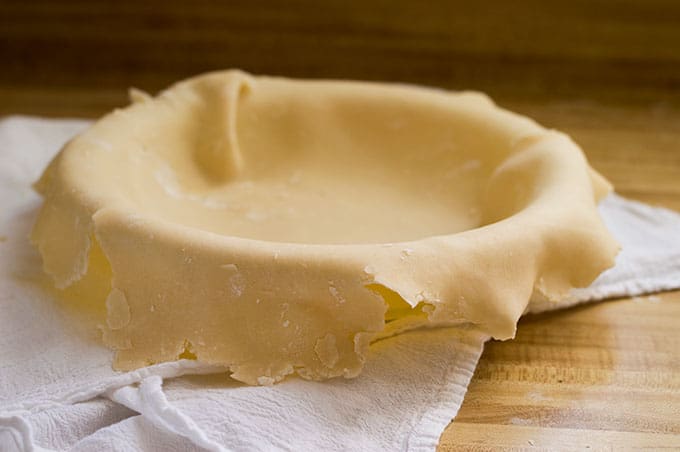 Pie dough covering a pie dish.