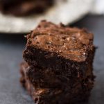 A close up of three stacked brownies.