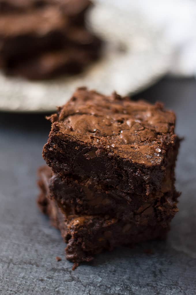 A close up of three stacked brownies.
