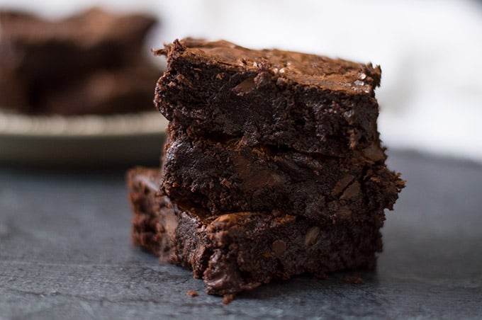 Close up of three stacked brownies.
