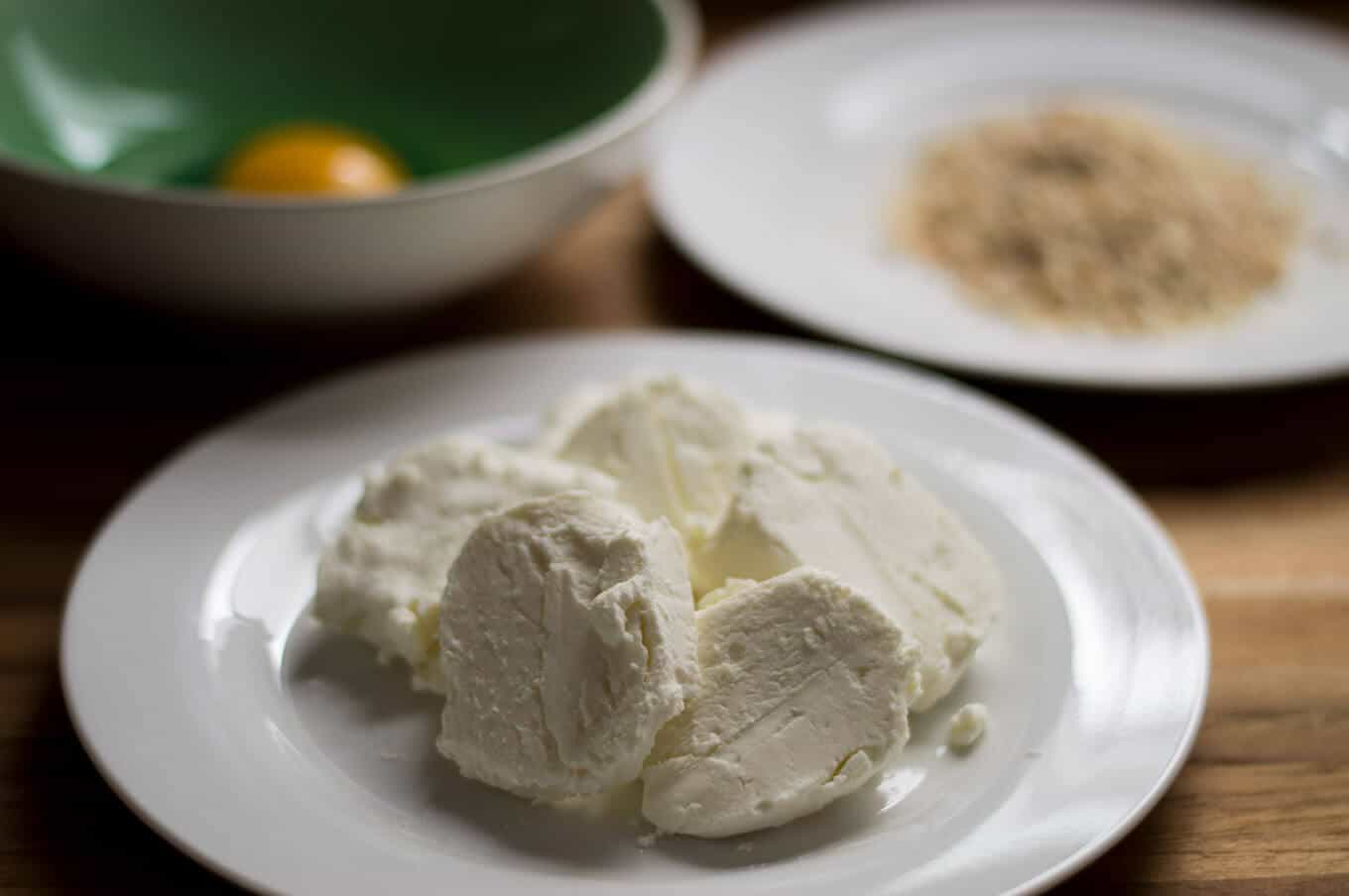 Close up of sliced goat cheese on a plate.