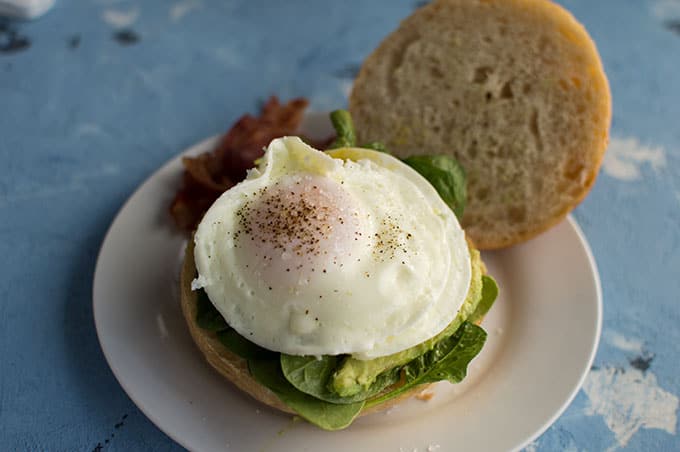 A close up of an open faced egg sandwich.