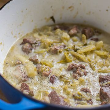 A dutch oven of pork and celery stew.