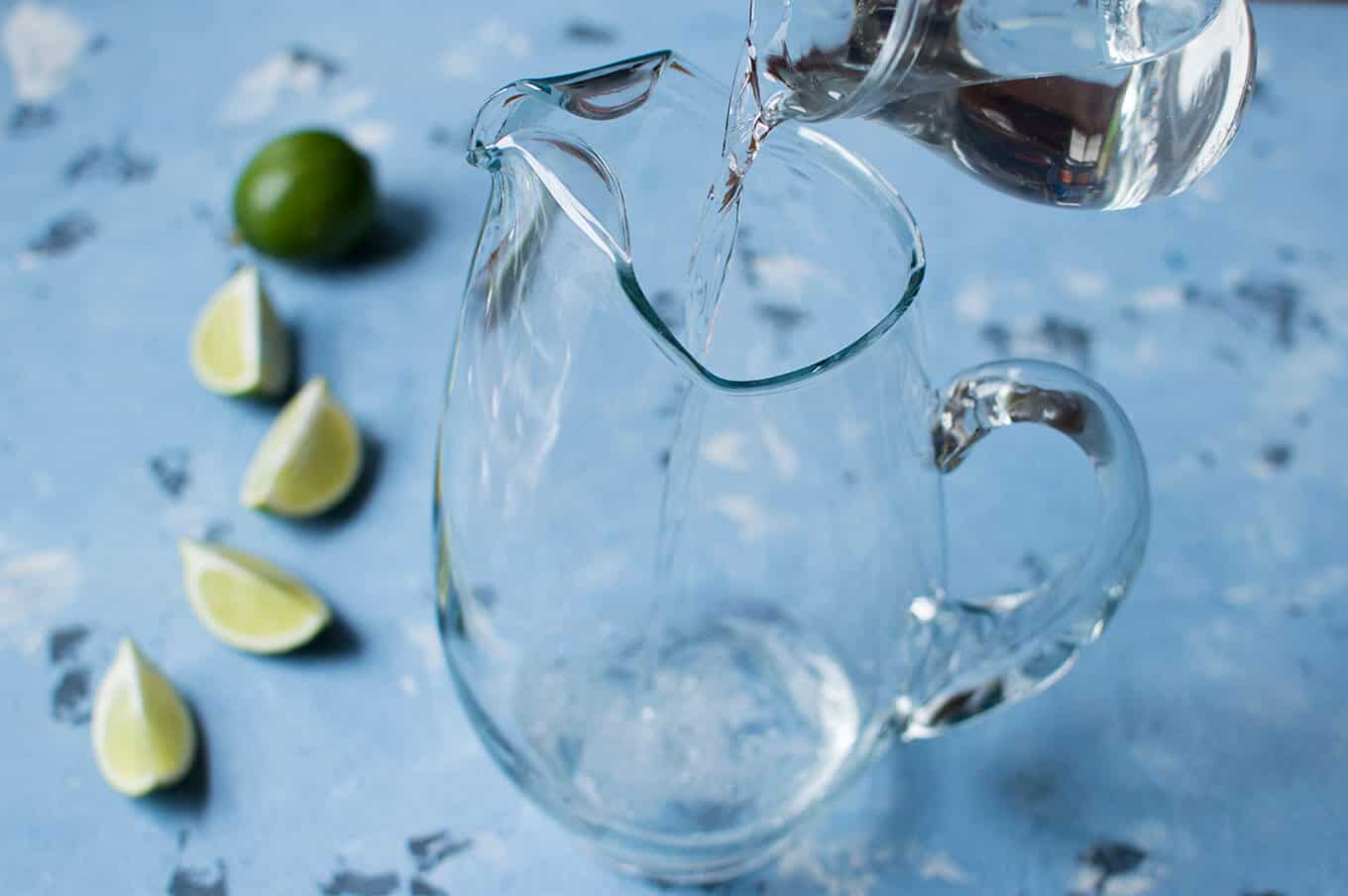 Tequila being poured into a pitcher.